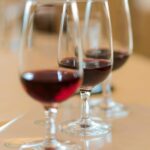 Close-up of red wine glasses in an elegant French setting, perfect for wine tasting experiences.