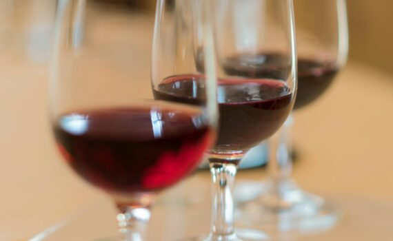 Close-up of red wine glasses in an elegant French setting, perfect for wine tasting experiences.